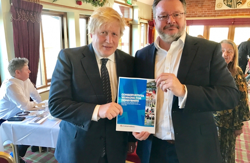 Cllr Lewis with Home Secretary Boris Johnson MP and the manifesto